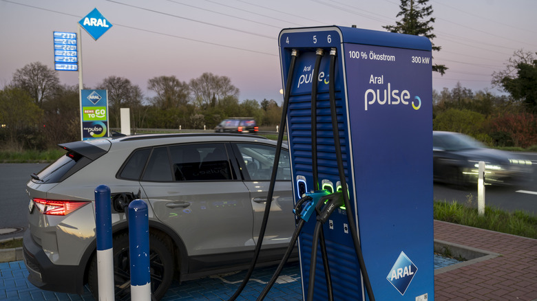 MOERFELDEN-WALLDORF, GERMANY - APRIL 01: A driver is charging his electric car at an Aral gas station on April 01, 2026 in Moerfelden-Walldorf, Germany. Electric car dealerships in Germany are reporting a rise in interest among buyers following the spike in gasoline prices due to the ongoing U.S.-Israeli war with Iran. (Photo by Thomas Lohnes/Getty Images)