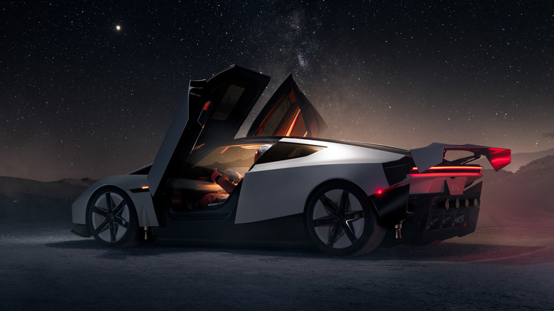 Tesla Roadster at night with doors open and wing extended