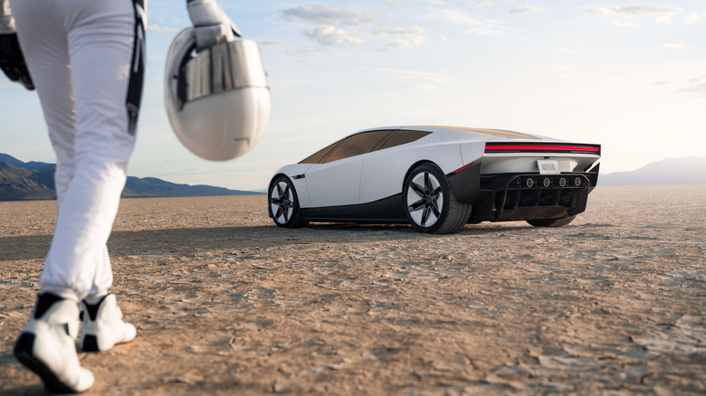 Person in space suit walking towards Roadster
