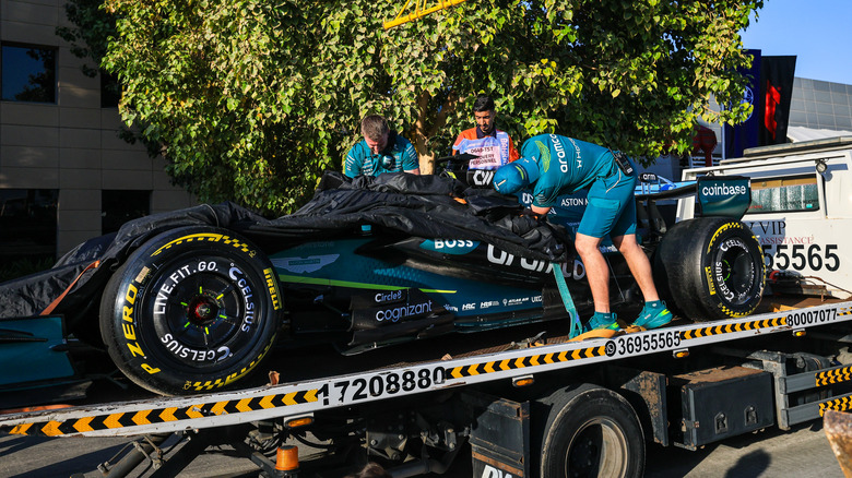 The stricken (18) Aston Martin AMR26 is recovered by the Aston Martin crew during day one of F1 Testing at Bahrain International Circuit on February 18, 2026 in Bahrain, Bahrain.