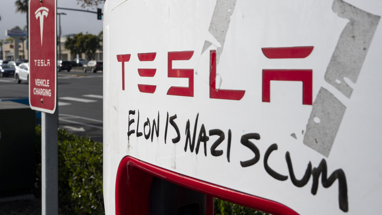 SAN DIEGO, CALIFORNIA - JANUARY 31: A Tesla Supercharger station is vandalized with the words Elon is a Nazi scum on January 31, 2025 in San Diego, California.