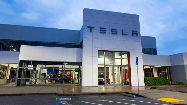 Front view of a Tesla store illuminated at dusk