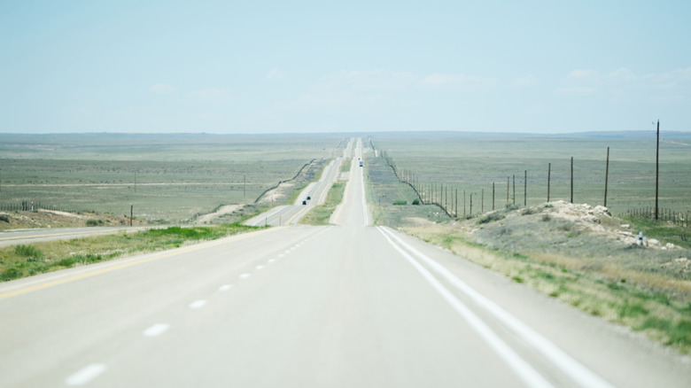 Long rural highway stretching into the horizon