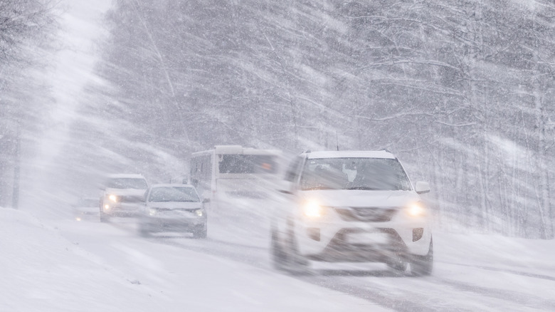 Vehicles driving through a heavy snowstorm