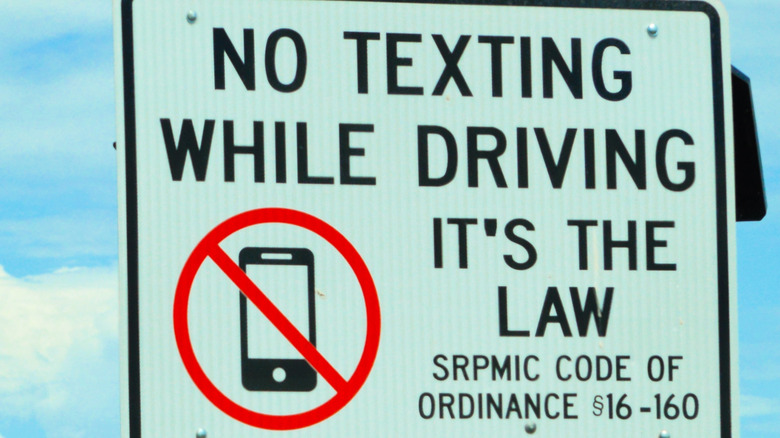 A road sign warning of texting and driving