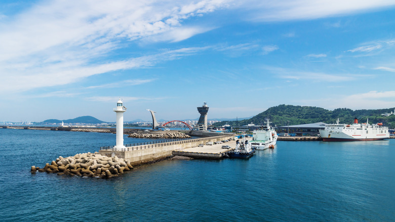 Jeju-si ferry terminal seen from the sea with lighthouse, Jeju-si, Jeju Island, South Korea