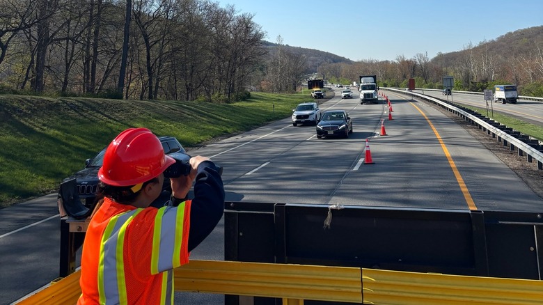 A New York State Trooper disguised as a highway worker observing traffic