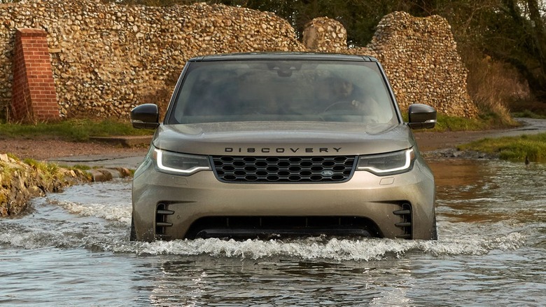 2025 Land Rover Discovery wading through water.