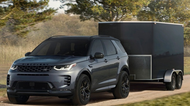 Gray Land Rover Discovery Sport pulling a trailer.