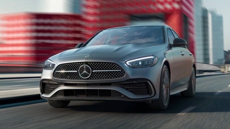 Gray Mercedes-Benz C-Class driving on a road.