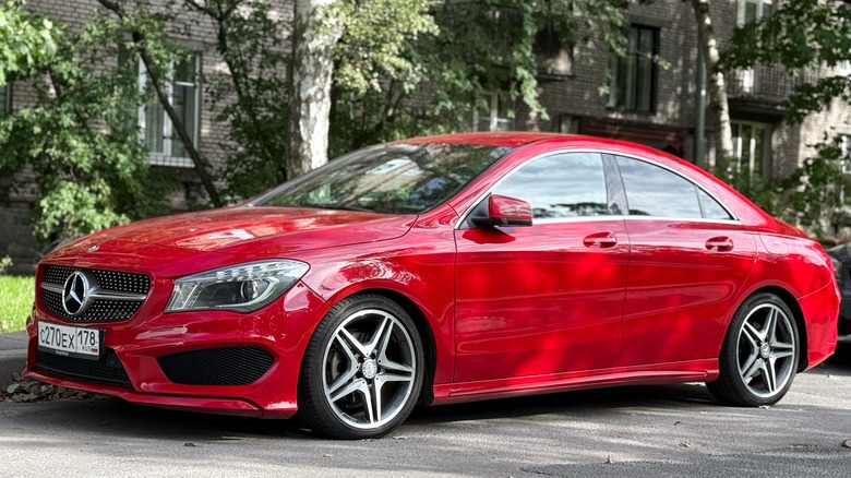 Red Mercedes-Benz CLA parked along a curb.