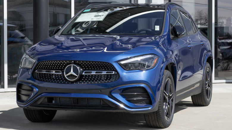 A Merceces-Benz GLA SUV sitting outside of a dealership.