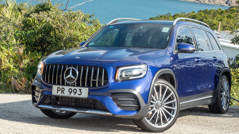 A blue Mercedes-Benz GLB parked near a lake.