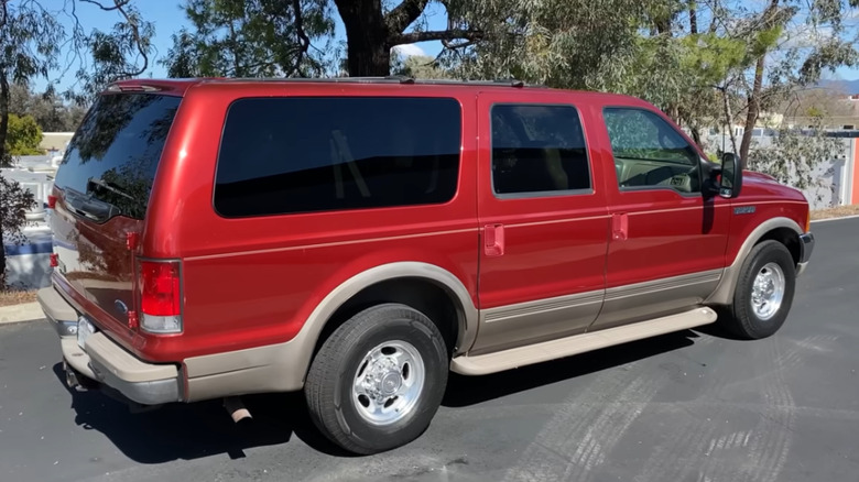 The rear 3/4 of a parked Ford Excursion