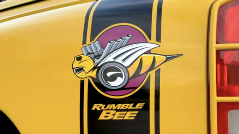 A bright yellow and black 2004 Dodge Ram Rumble Bee logo