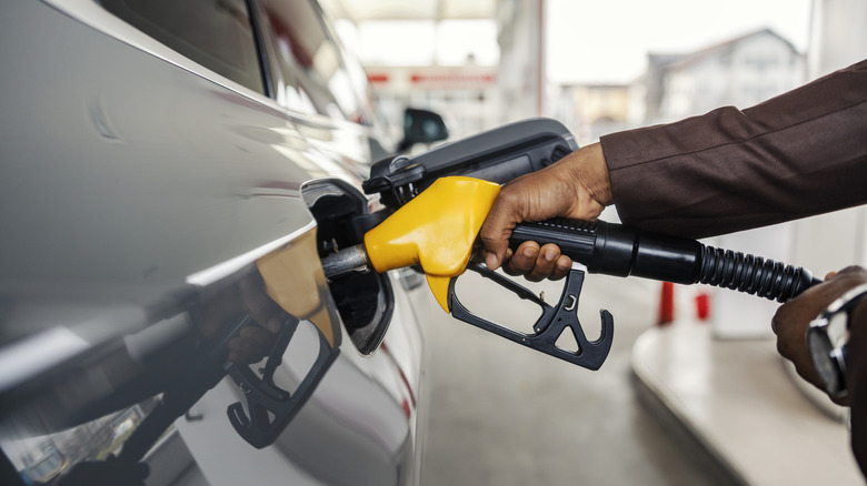 A person filling a car with fuel.
