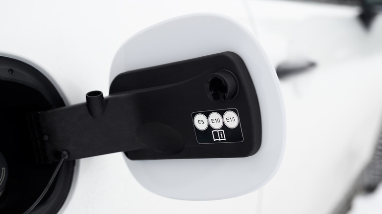 The inside of a car's fuel cap outlining ethanol compatibility.