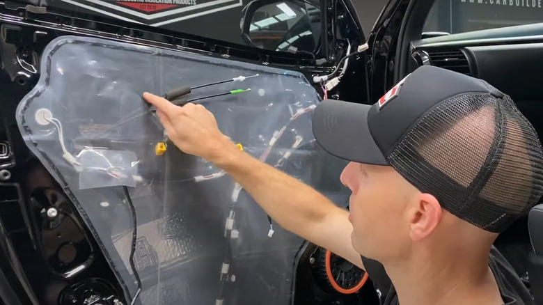 Picture of a man installing a new door card membrane