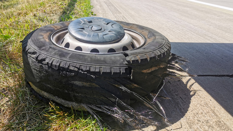 A damaged semi-truck tire which caused a blowout and an accident