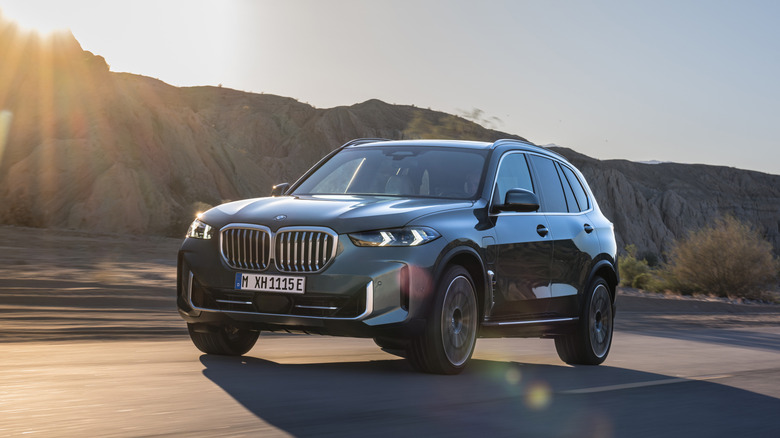 A gray BMW X5 on a roadway.