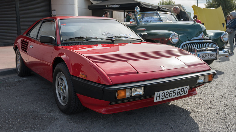 A red Ferrari Mondial sports car parked on display.