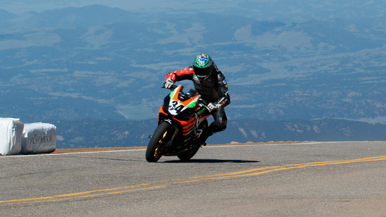 Rennie Scaysbrook driving at the 2019 Pikes Peak hill climb aboard an Aprilia Tuono 1100 Factory