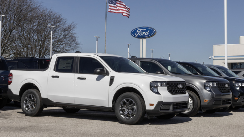 A line of pickup trucks at a Ford dealership