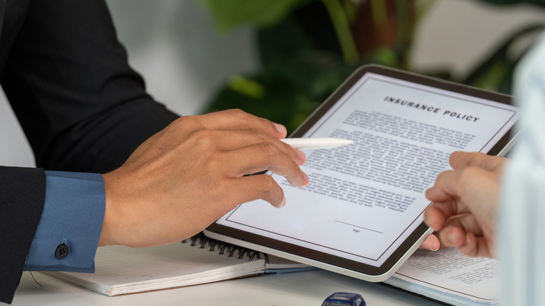 Looking at car insurance policy details on a tablet
