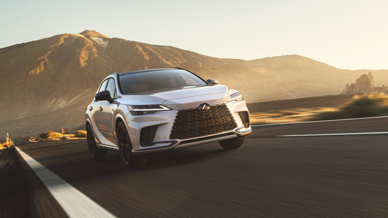 A 5th-generation 2023 Lexus RX 500h on an empty stretch of road