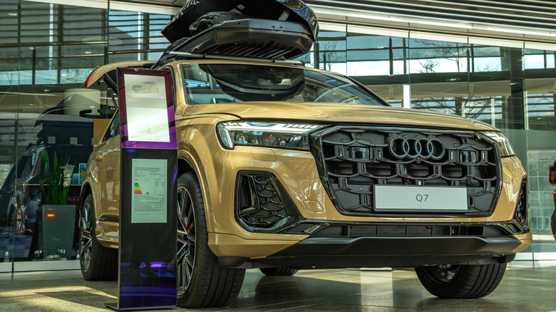 A yellow Audi Q7 on display at a dealer