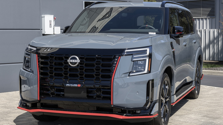 A grey 2026 Nissan Armada NISMO parked by a building