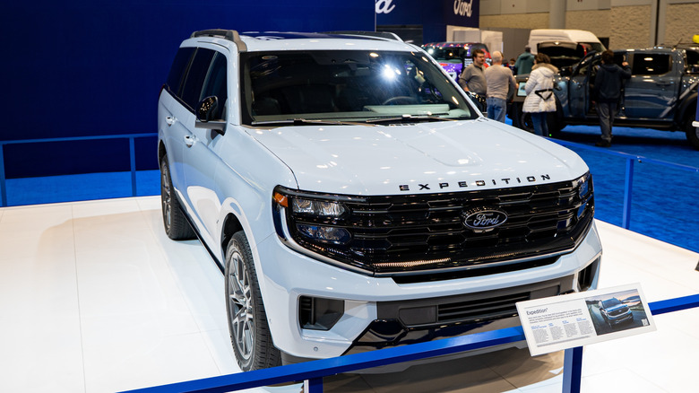 A white ford Expedition at a car show