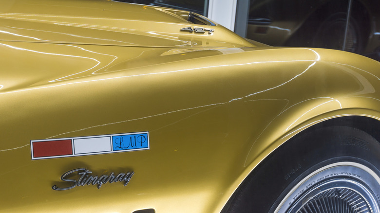 Close up of unique fender badging on Al Bean's gold Corvette Stingray