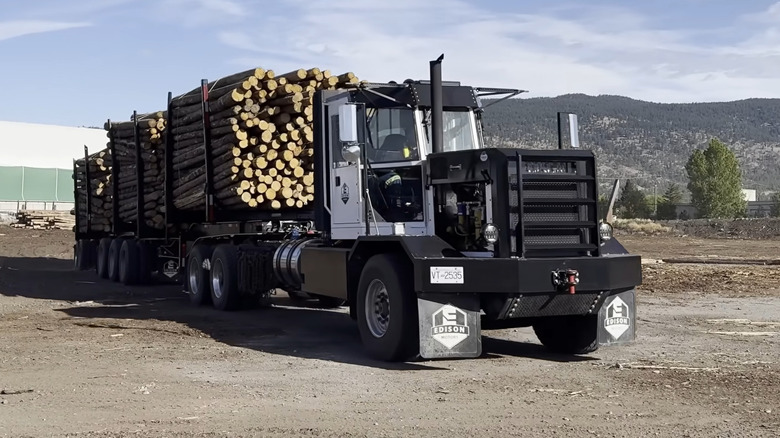 An Edison Motors diesel electric truck hauling logs