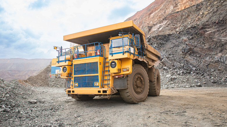 A yellow diesel-electric mining truck in a quarry