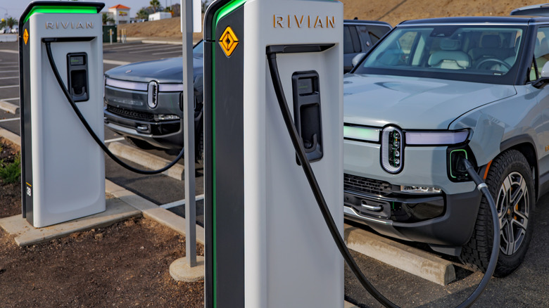 Two Rivian vehicles connected to nan Rivian Adventure Network of EV chargers
