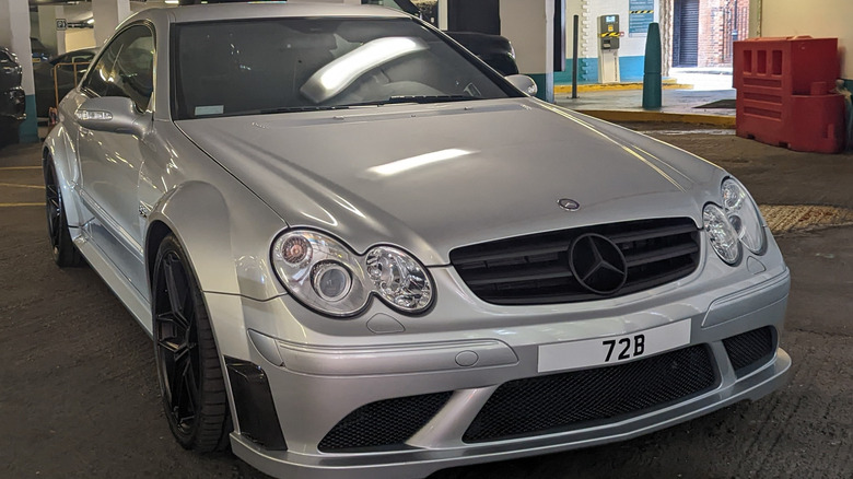 A 2008 Mercedes-Benz CLK63 AMG Black Series sits in a showroom.
