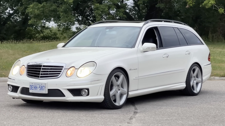 A white Mercedes-Benz E55 AMG Wagon sits parked.