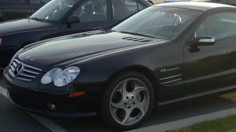 A black Mercedes-Benz SL55 AMG sits parked.