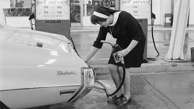 A nun puts gas in her car