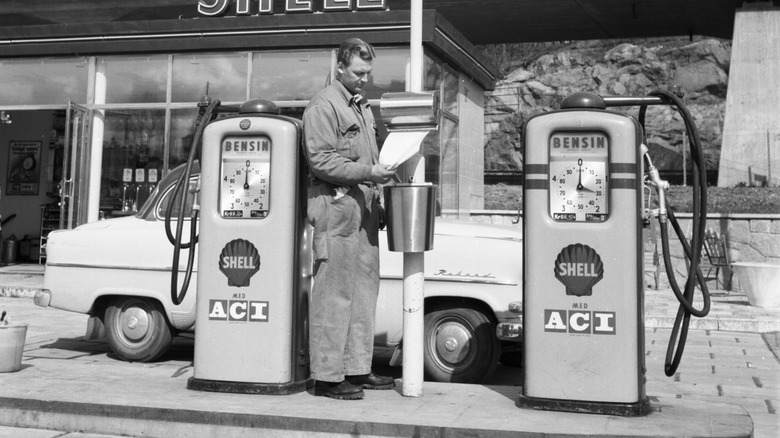 Gas station attendant grabs a paper towel