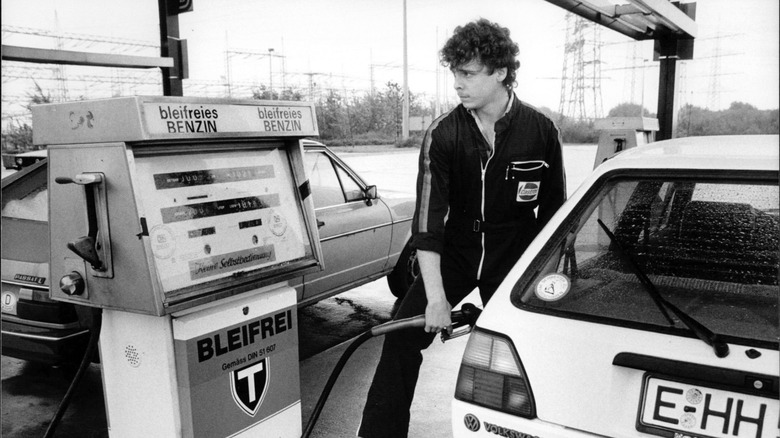 A German refuels a Volkswagen