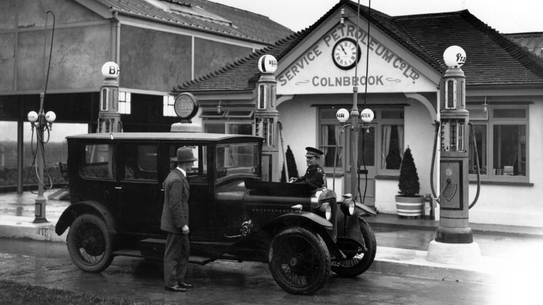 1920s car stopped at a fuel station