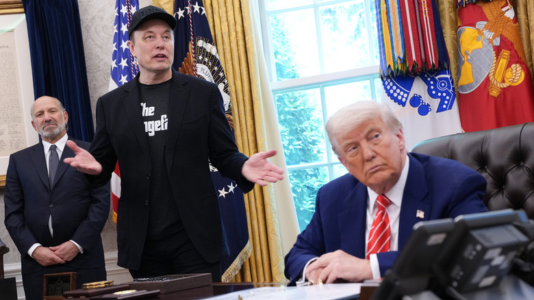 Howard Lutnick, Elon Musk, and Donald Trump in the Oval Office.