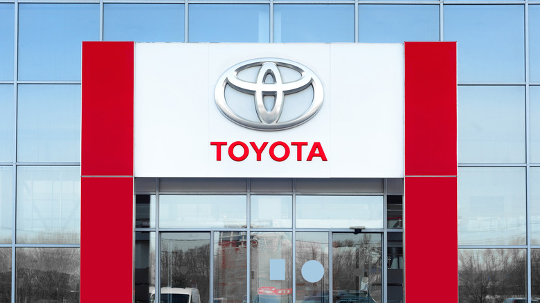 Facade of nan Toyota Motor car dealership, opens its doors