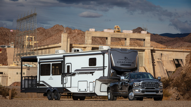 a black DRW Ram 3500 dually pulling a large motorhome