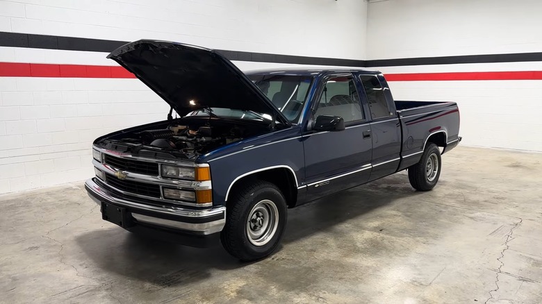 A 1998 Chevy 1500 with its hood open, showing a 5.0L Vortec engine underneath