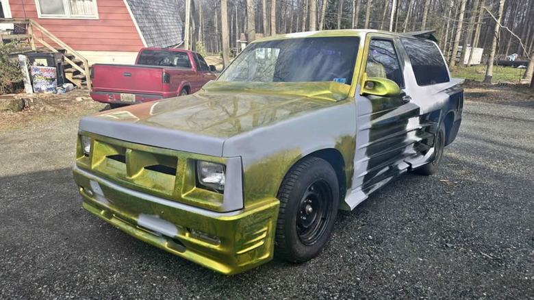 A green and black Chevy Blazer with Testerossa body cladding
