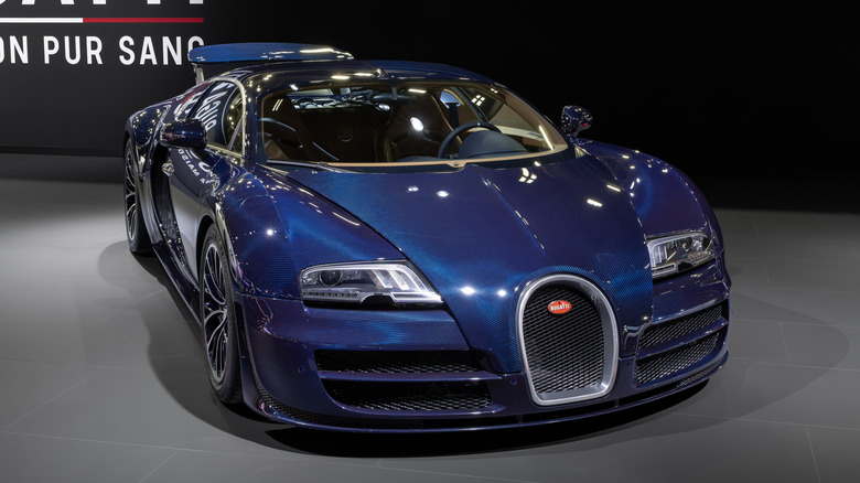 Full exposed blue carbon Bugatti Veyron Super Sport parked on display.