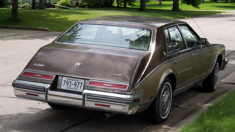 A rear view of a brown 1981 Cadillac Seville Bustleback.